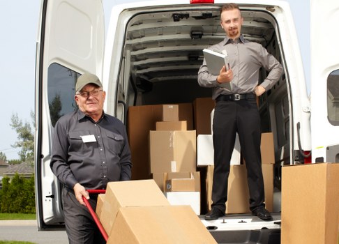 Moving van and packed boxes during house removals in Neasden